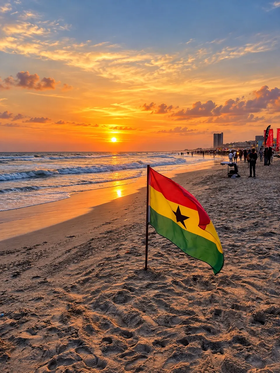 Golden sunset over the coast with a Ghana flag on the sand